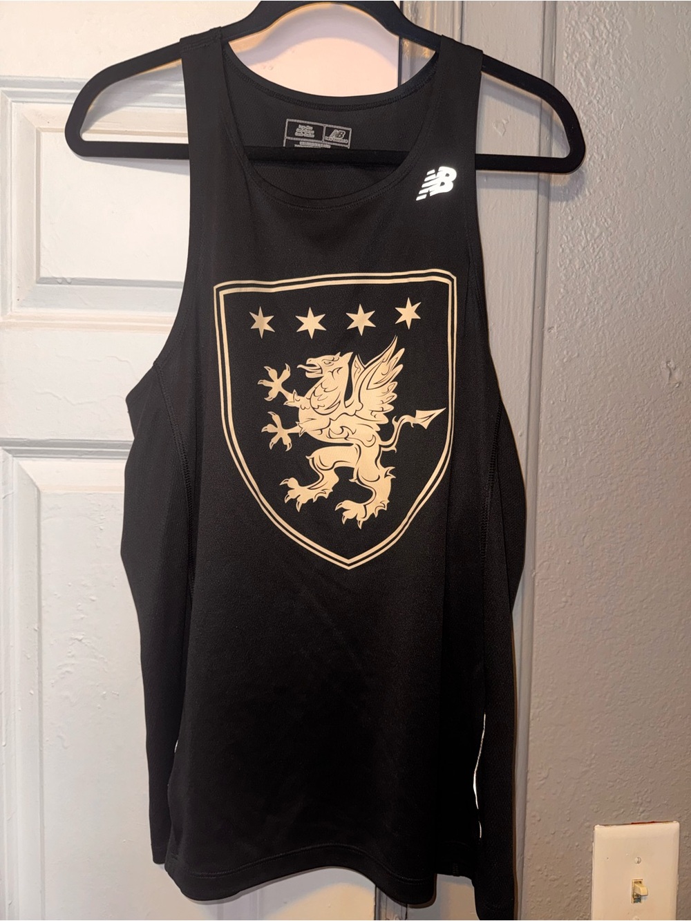 New Balance Black Sports Tank with Gold Crest Shield design